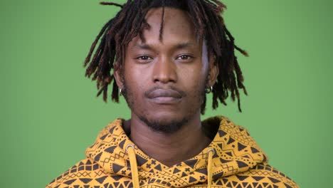 young handsome african man covering mouth as three wise monkeys concept