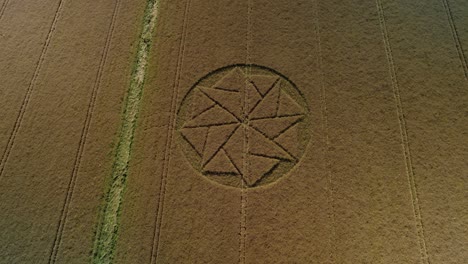 wheat harvest crop circle farmland symbol aerial tilt up pull back view stanton st bernard wiltshire