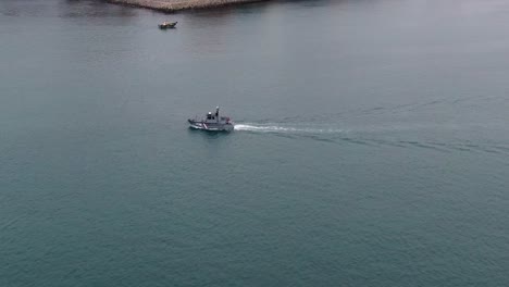 peruvian coastguard patrol vessel navigating across the callao harbor in lima, peru