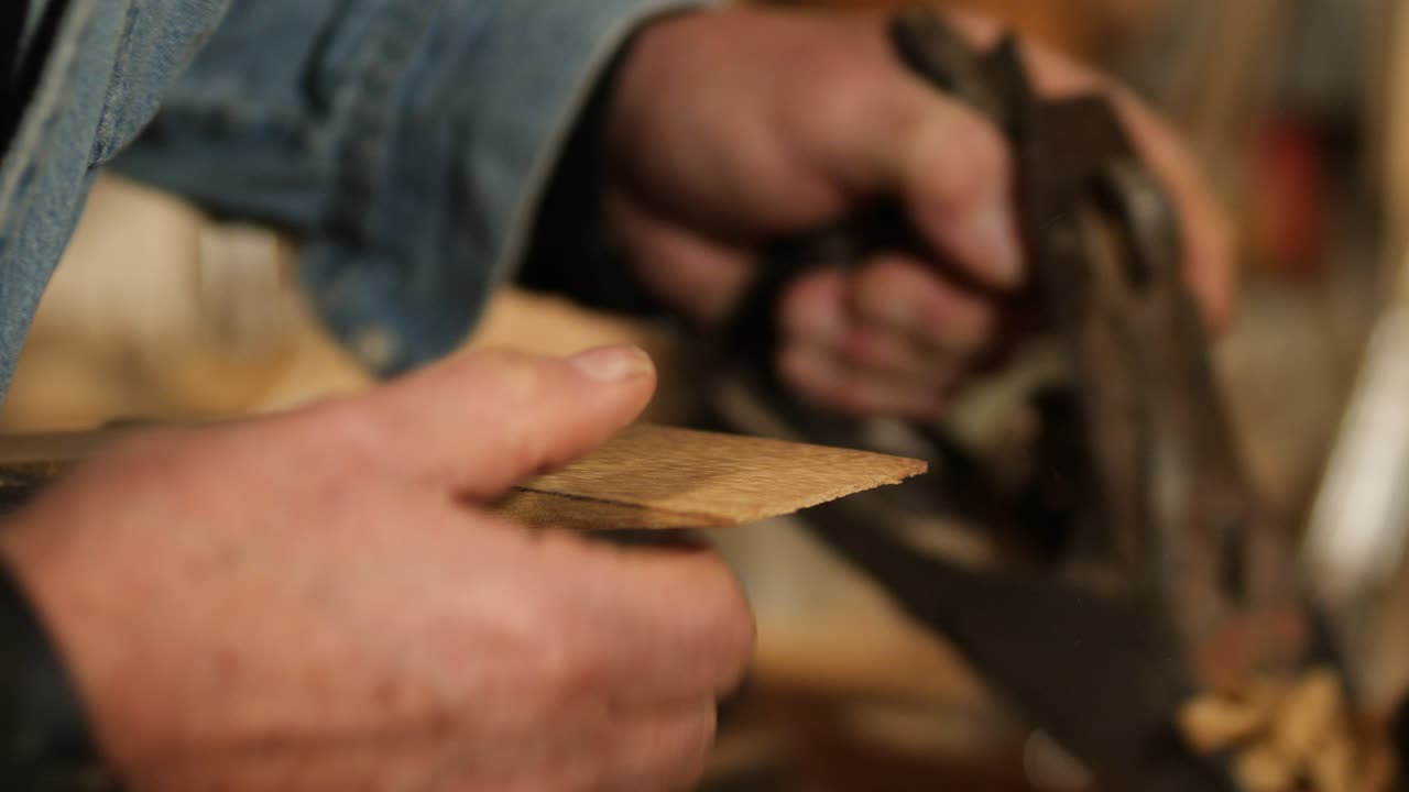 Skilled artisan shaping wood with a classic hand plane