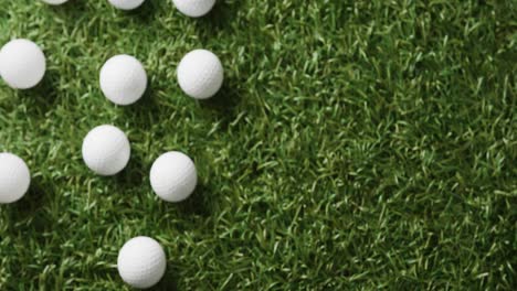 close up of golf balls on grass, copy space, slow motion