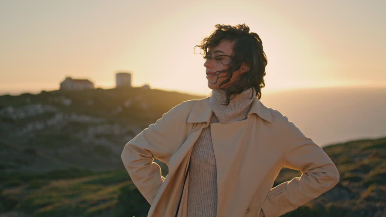 Romantic girl posing sunset at vertically view. Carefree tourist enjoy evening