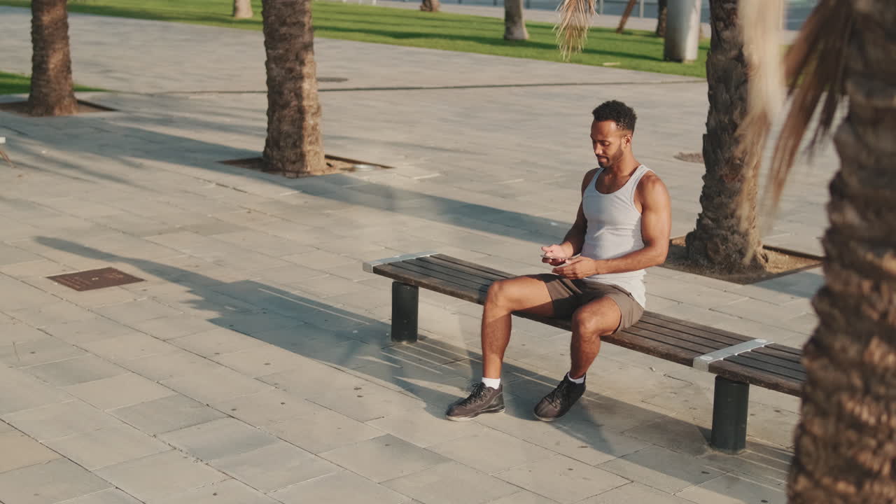 Man Resting on Bench in Urban Park