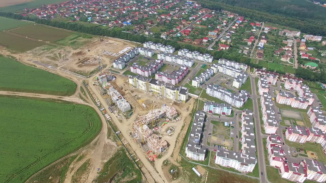process of building modern high-rise buildings in the new part of the city. View of the buildings on the outskirts of the city. Aerial view.