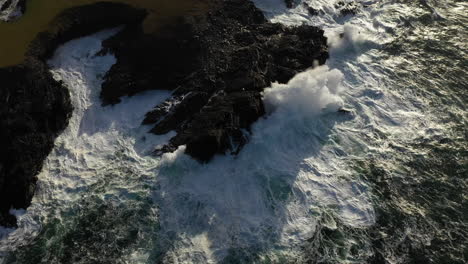 down tilt cinematic drone shot of the white cliffs of ashleam, ireland with waves crashing