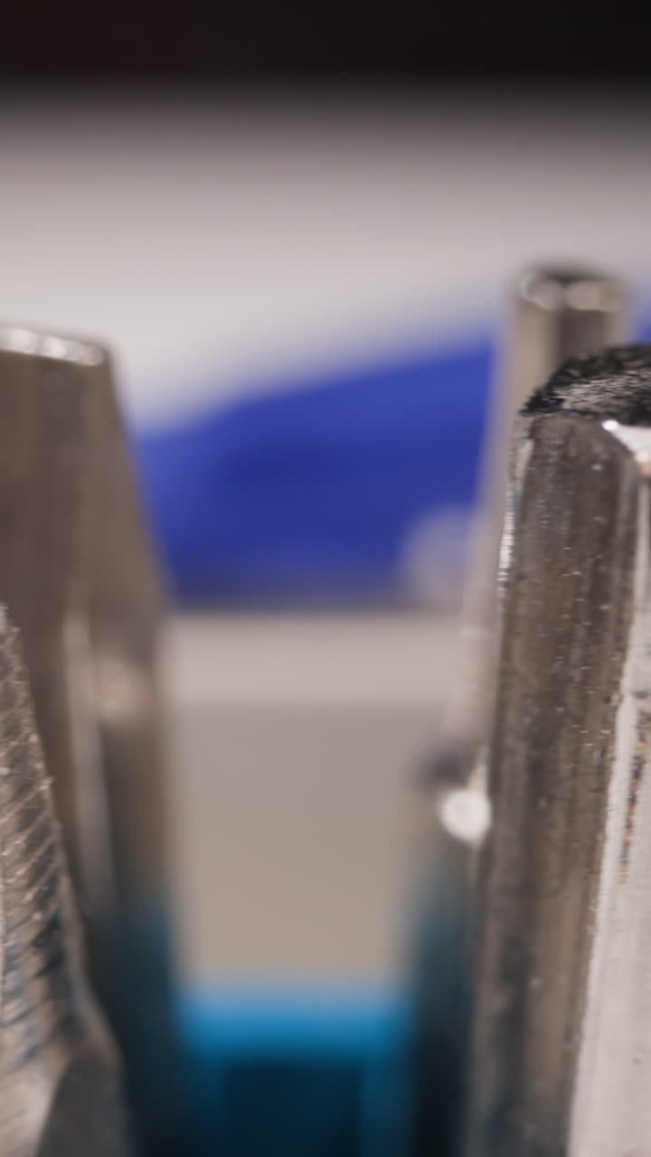 Collection of different shaped metal bits for screwdriver in toolbox on blurred background macro view. Professional handyman supplies for craft