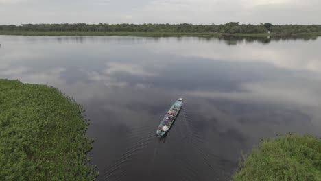 Aerial-View-Of-Motorboat-With-Tourists-Sailing-In-Laguna-Negra,-Colombia---drone-shot