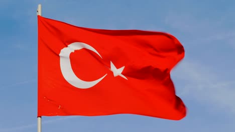 flag of turkey is waving on background of clear blue sky in sunny day