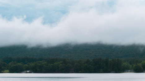 Cloudy-mountains-looking-over-a-foggy-lake-time-lapse
