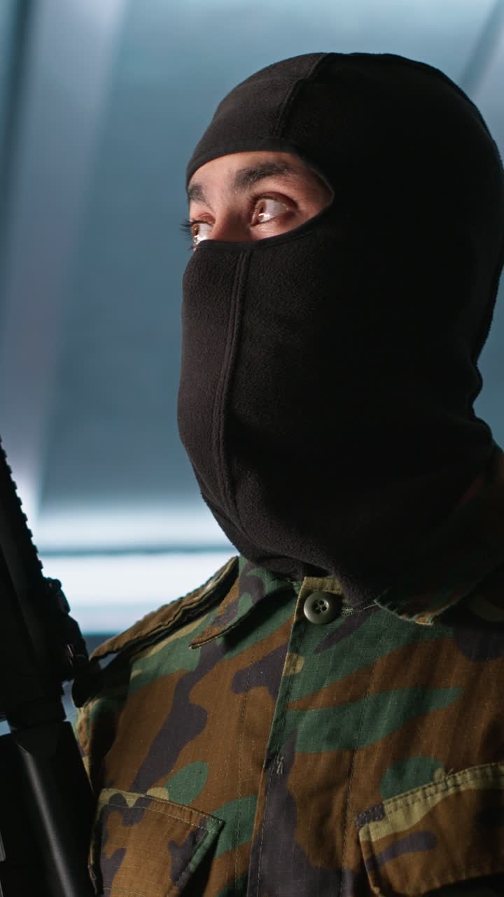 Vertical video Rebel forces insurgent with weapons in hidden base