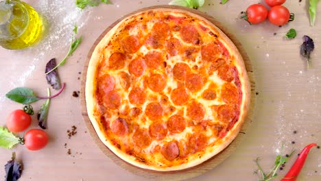 chef in rubber gloves takes pizza salami on a wooden board from the table.