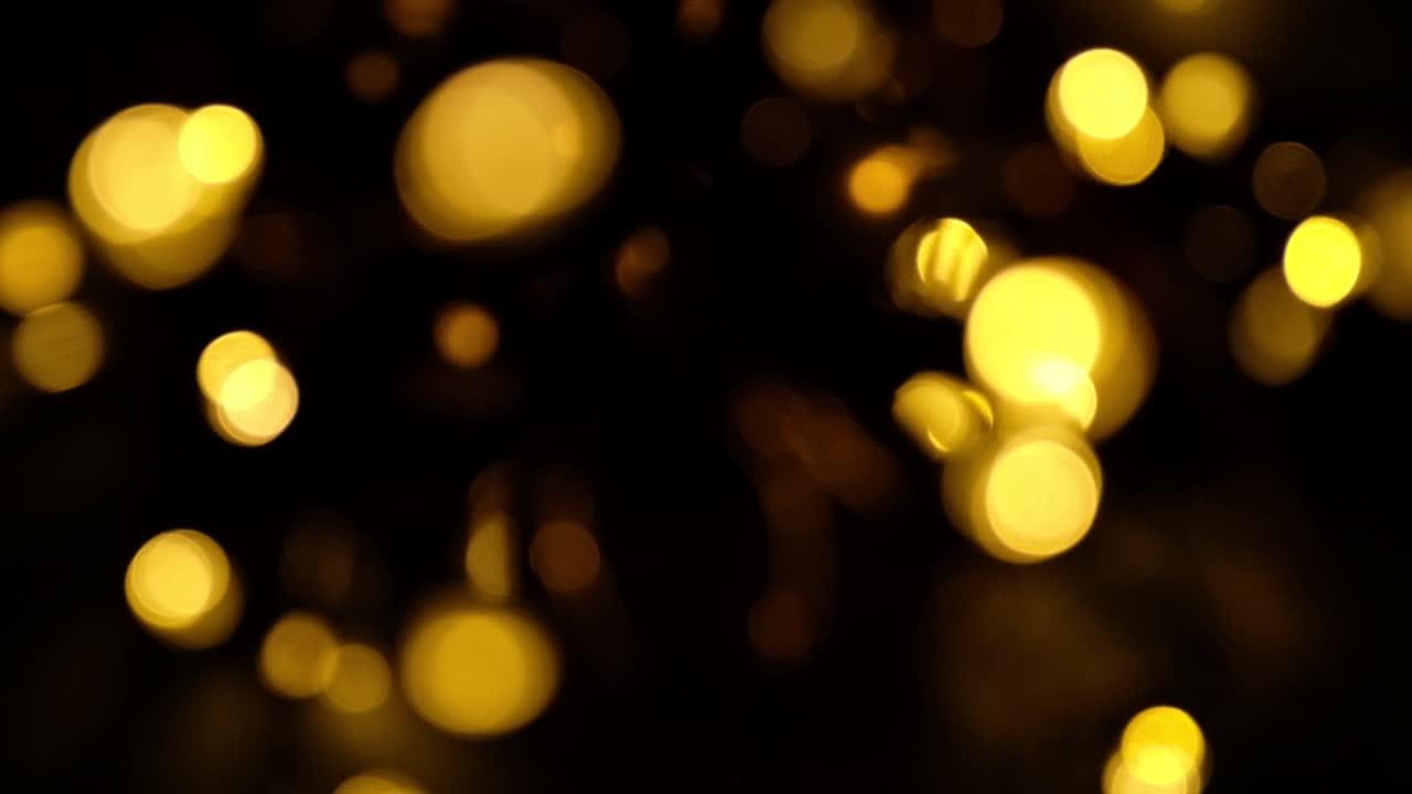 bokeh of evening lights in windy weather, christmas yellow garlands blur bokeh