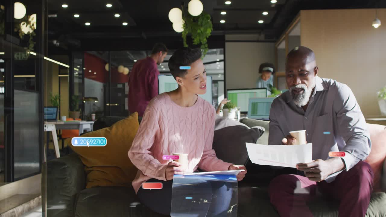 Woman pointing and speaking on couch, man reading documents for business review causing UI labels