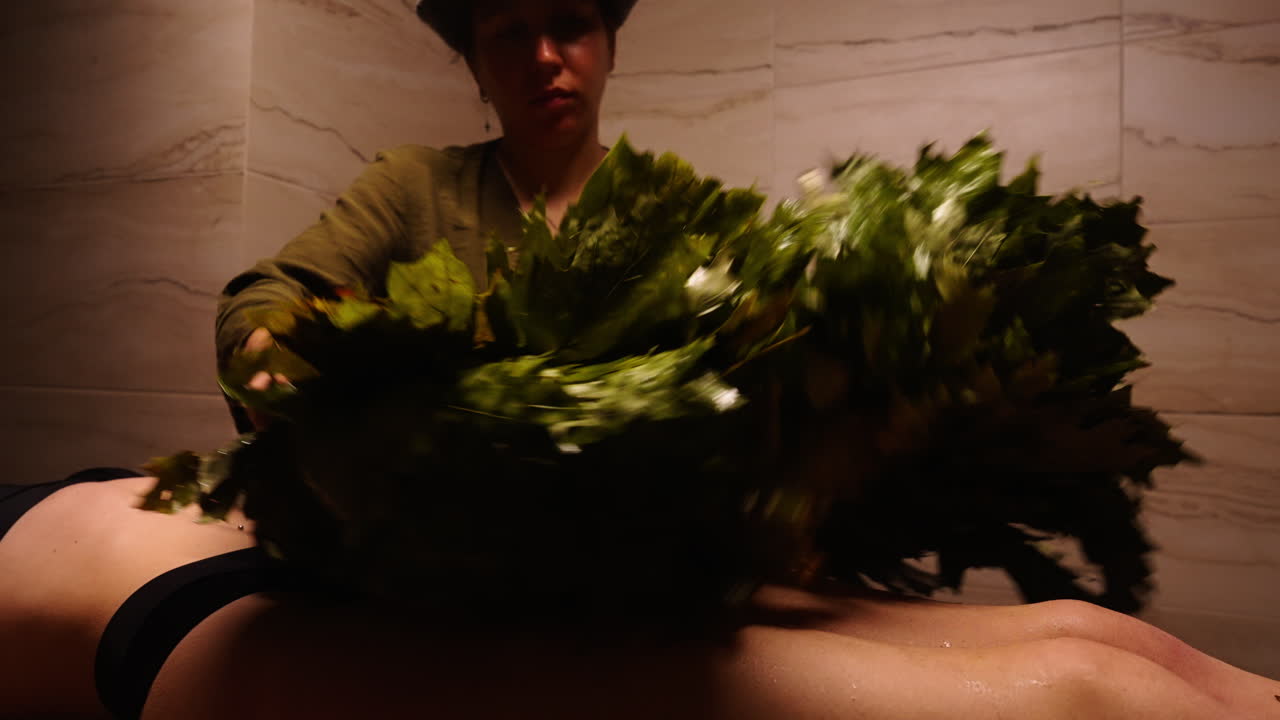 Woman getting a banya treatment