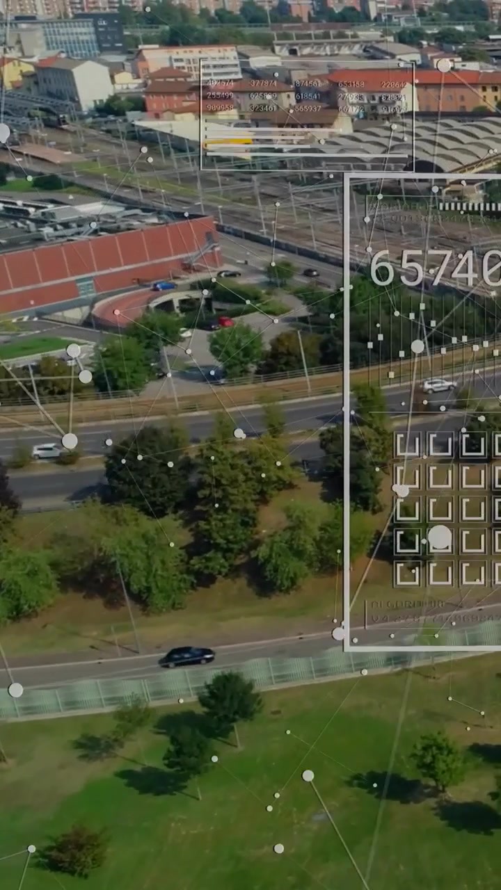 Vertical video: Camera rising and panning, showing park, rail yard while HUD updating traffic data