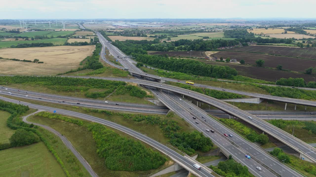 Aerial drone view of busy motorway interchange with flyovers and junctions, showing traffic and highway infrastructure near Birmingham England UK
