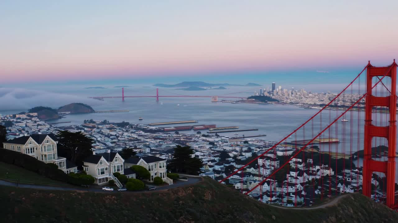 Aerial video captures a scenic view of San Francisco at dawn, showcasing the Golden Gate Bridge