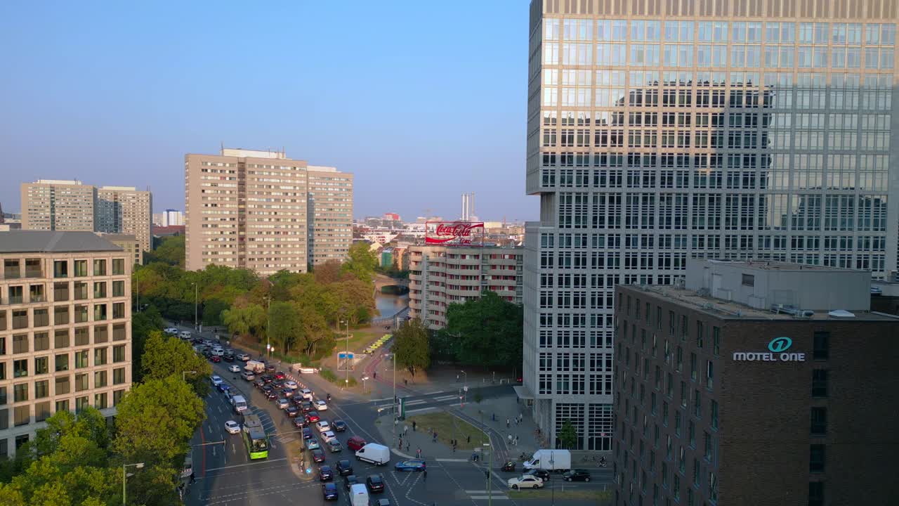 Berlin cityscape with residential buildings, a coca cola billboard, and cars moving along the streets. Best aerial view flight panorama overview drone