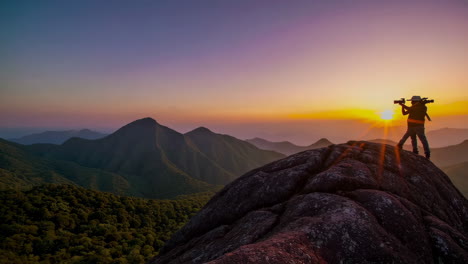 photographers capturing a stunning sunset from a mountain peak