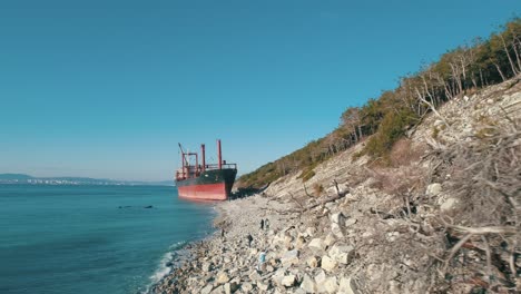 abandoned cargo ship on a rocky coastline