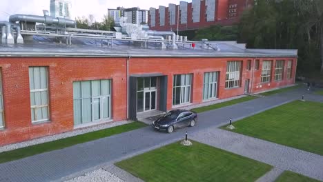 aerial view of modern brick building with parking lot