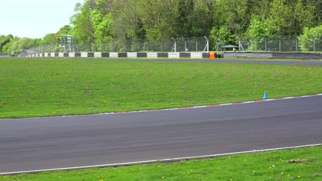 stock cars race around a track 2