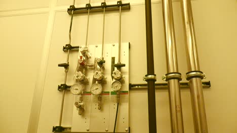 a shot of valves, pipes and barometers in a laboratory or the clean room at delft university