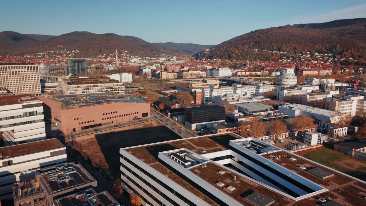 Sustainable Urban Hub: Aerial of Heidelberg's Bahnstadt Transition Zone, Featuring Modern Research and Residential Architecture with Train Lines in the Foreground
