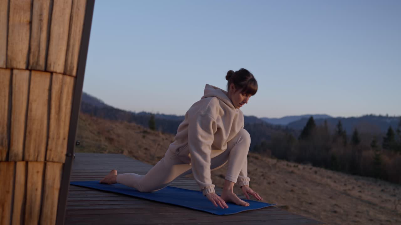 Woman doing yoga in the mountains