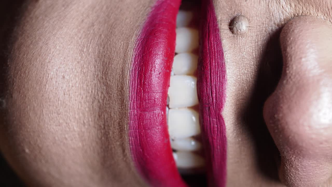 Woman with red lipstick smiling