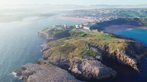 slow drone dolly shot backward and down, suances coast, spain