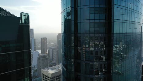 Ascending-aerial-shot-of-Brisbane's-'The-One'-Skyscraper-with-other-buildings,-river-and-Brisbane-CBD-being-visible-in-background