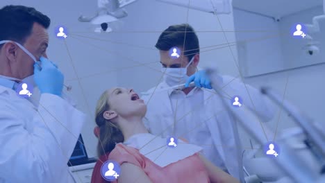 animation of network of connections with icons over caucasian male dentists and female patient