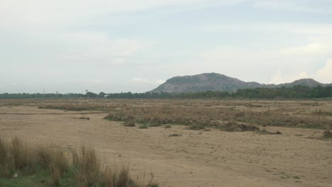 Panoramic-view-of-sacred-Falgu-River-dry-waterbed-with-a-long-stretch-of-sand-dunes,-Bodhgaya,-Bihar,-India