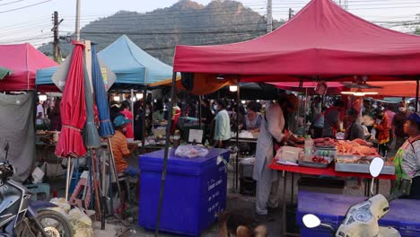 vendors and shoppers at a busy market