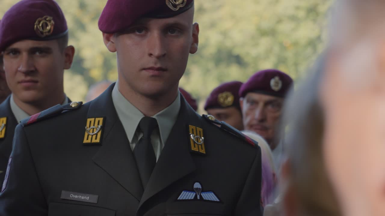 Close-up of soldier in formal military uniform attending memorial service at Oosterbeek War Cemetery. The solemn event honors the fallen soldiers from World War II. Oosterbeek, Gelderland, Netherlands