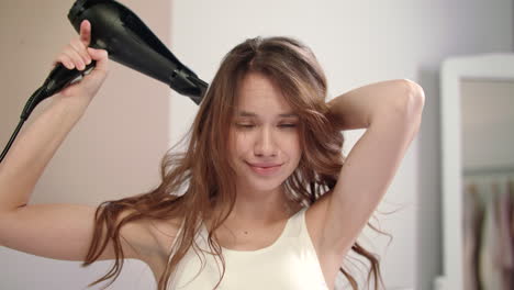 Brunette-woman-drying-hair.-Portrait-of-beautiful-woman-dry-hair-at-morning