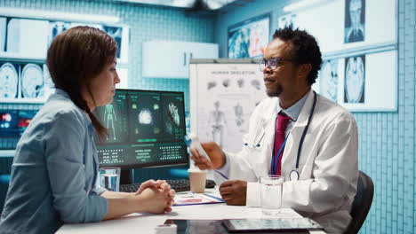 african american specialist consulting a young woman in medical office