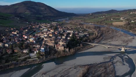 Imágenes-Aéreas-De-Aterrizaje-De-Drones-Al-Atardecer-De-La-Aldea-De-Travo-En-El-Valle-Del-Río-Trebbia,-Piacenza,-Italia