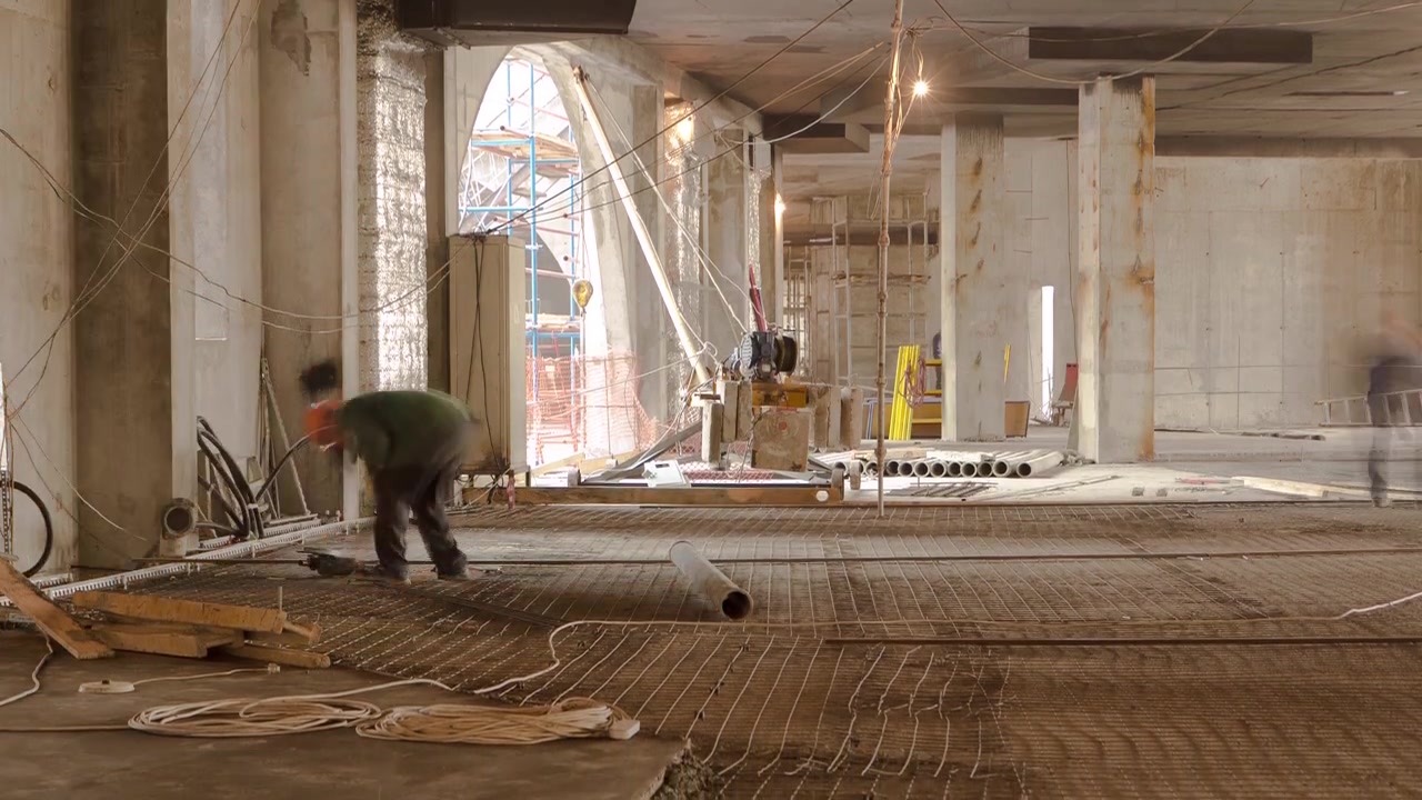 Construction works with circular abrasive cutoff saw angle grinding machine and sparkles timelapse. Construction works inside a building