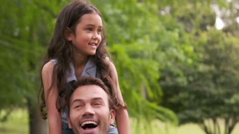 Handsome-father-giving-piggy-back-to-his-daughter