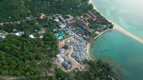 aerial establishing of koh phangan with its tranquil beaches, crystal-clear waters, and vibrant greenery surrounding the shoreline