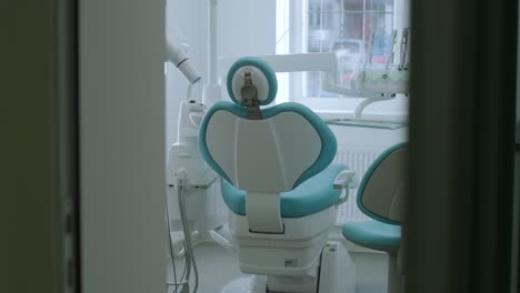 modern dental practice. dental chair and other accessories used by dentists in blue, medic light. fisheye