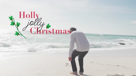 Animation-of-holly-jolly-christmas-text-over-senior-biracial-man-at-beach