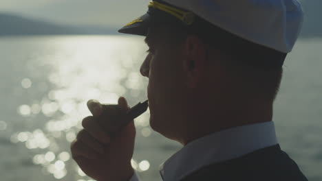 captain smoking a pipe at sunset