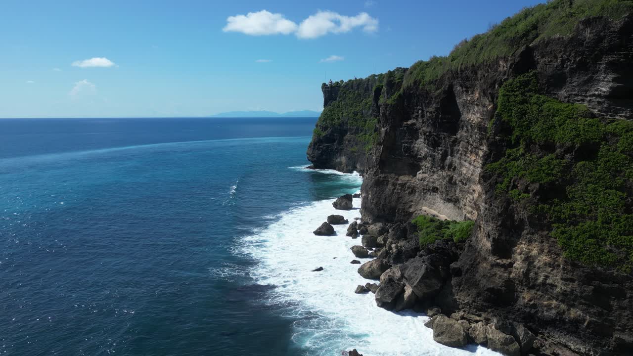 los acantilados de uluwatu, bali en un día caluroso de verano con las olas chocando contra las rocas, aero