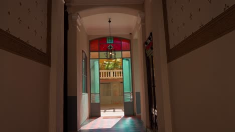 slow push-in shot of an internal courtyard in a milanese-style building with elegant architecture and vibrant stained glass windows in milan milano italy