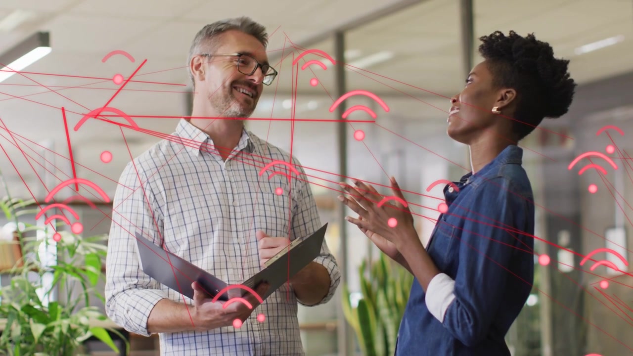 Lead pointing at folder, peer leaning in reviewing business docs, red network overlay linking pages
