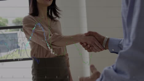 statistical data processing against businessman and businesswoman shaking hands at office