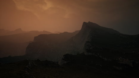 dramatic sky over rocky mountains at sunset